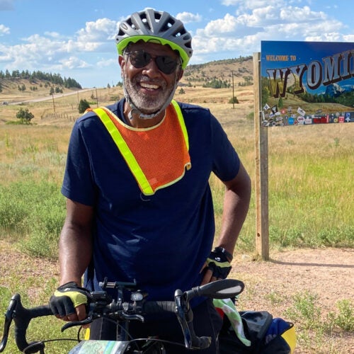 Scott Edwards on bicycle entering Wyoming.