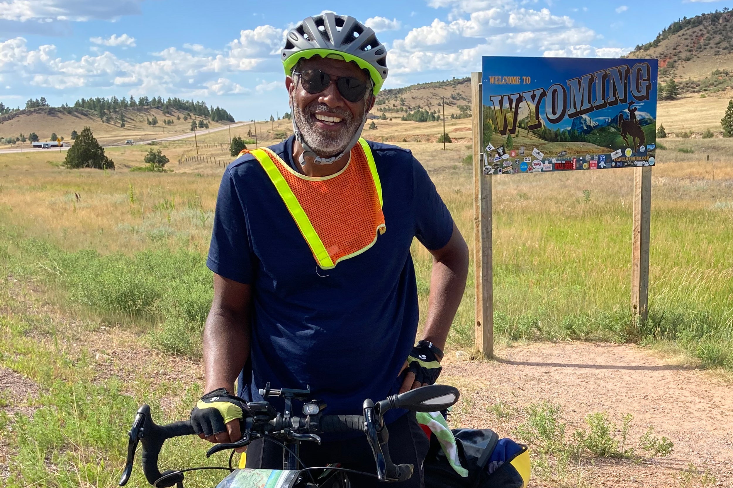 Scott Edwards on bicycle entering Wyoming.