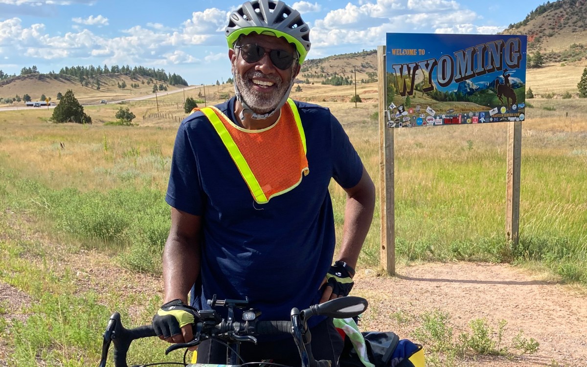 Scott Edwards on bicycle entering Wyoming.