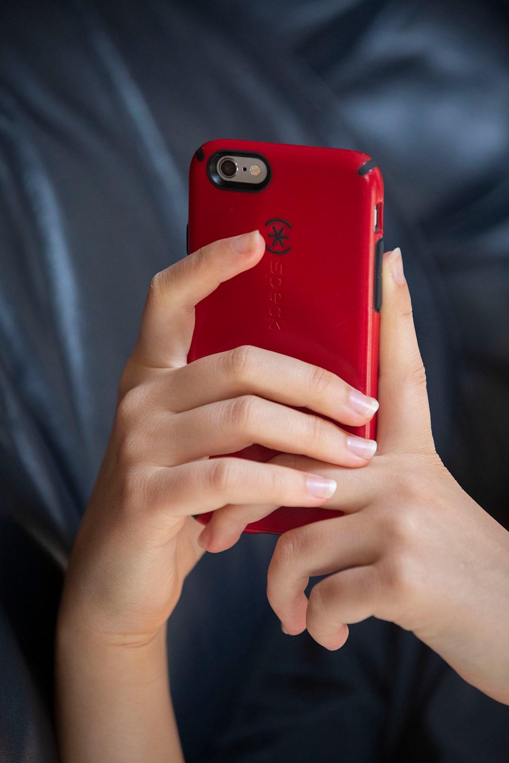 Hands holding a smartphone.