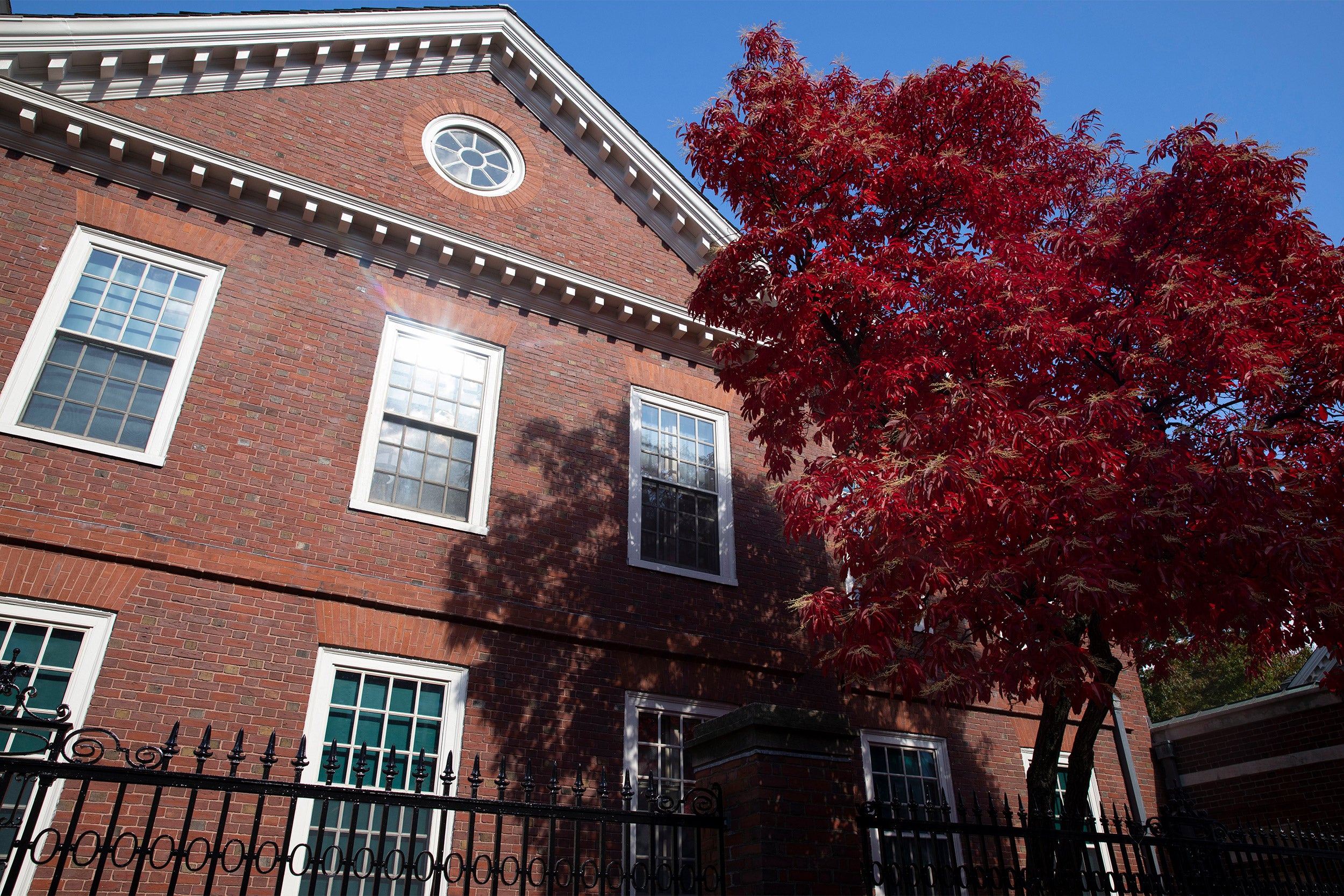 Crimson foliage frames Wigglesworth House in Harvard Yard.