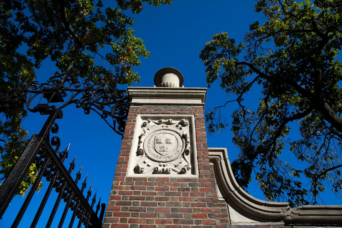 A veritas shield decorates a gate that encircles Harvard Yard.