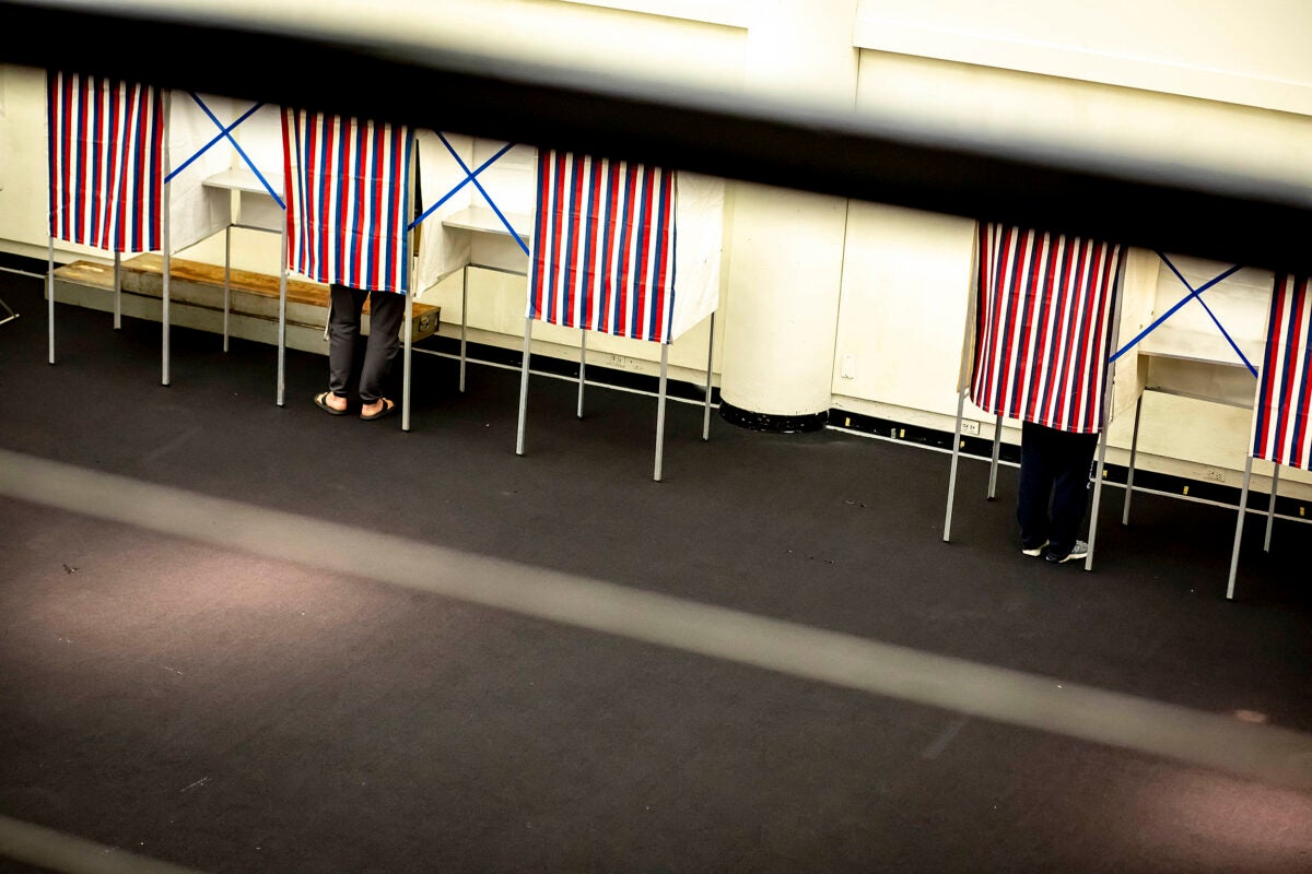 People in voting booths.