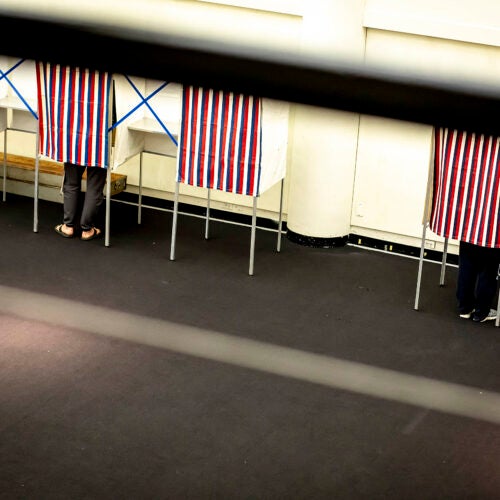 People in voting booths.
