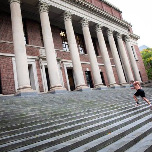 Man running steps at Widener Library.