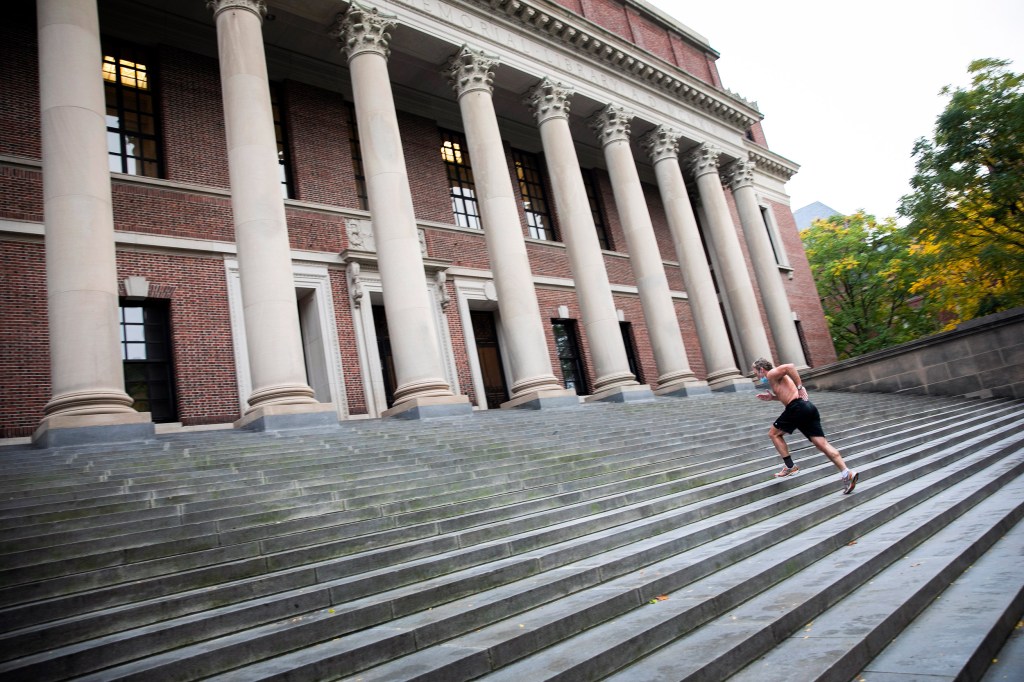 Man running steps at Widener Library.