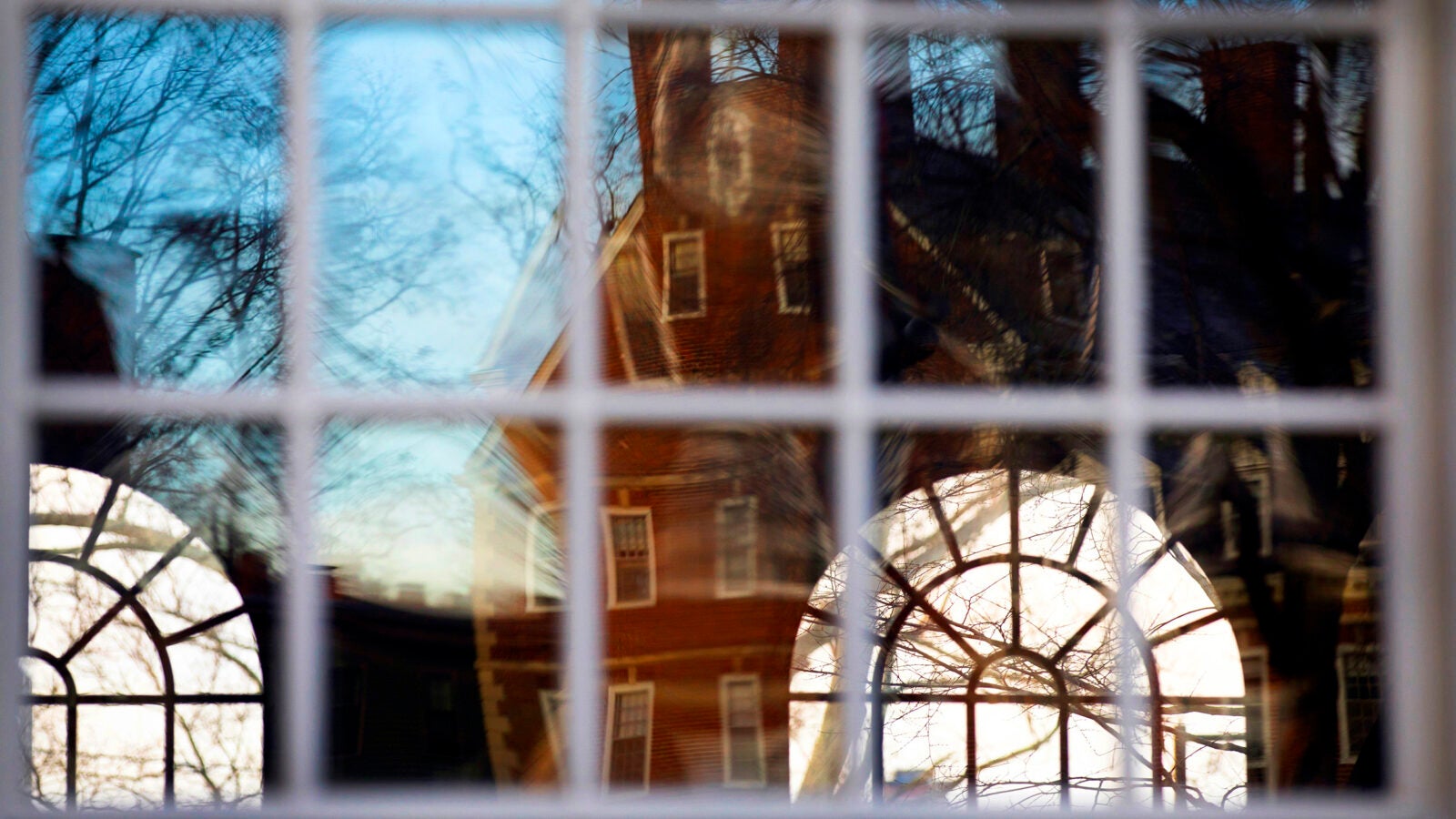 Kirkland House is reflected in the windows of Winthrop House.