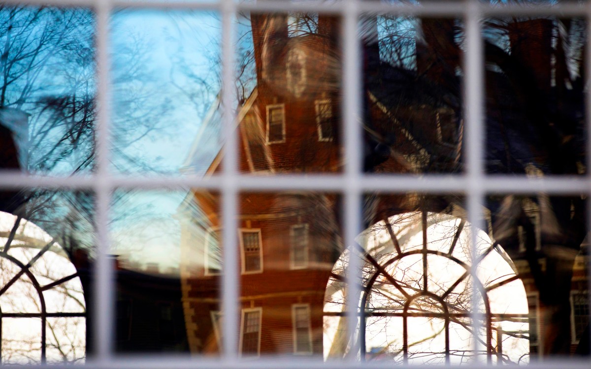 Kirkland House is reflected in the windows of Winthrop House.