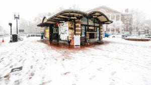 The Former Out of Town News Stand is covered in snow.