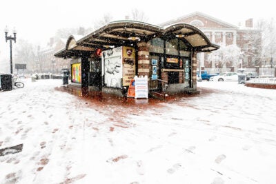 The Former Out of Town News Stand is covered in snow.