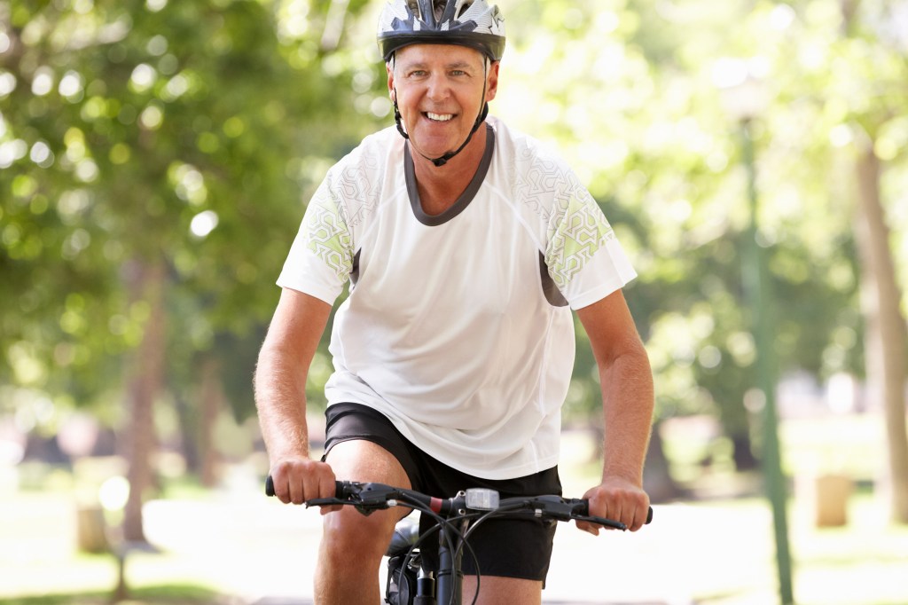 Older man riding a bike.