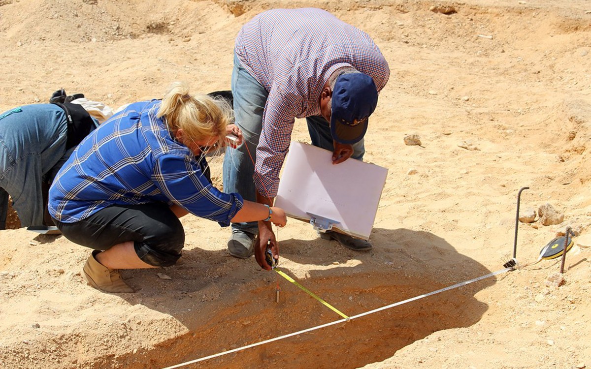 Two people at an archaeology site.