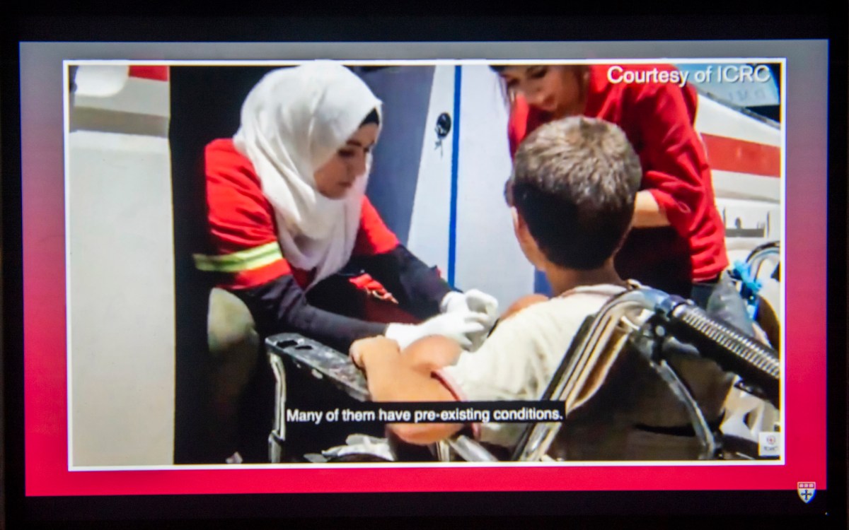 Red Cross worker helping boy.