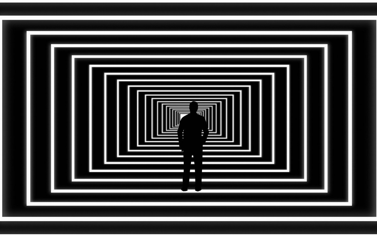 Illustration of person looking at light at end of abstract tunnel.