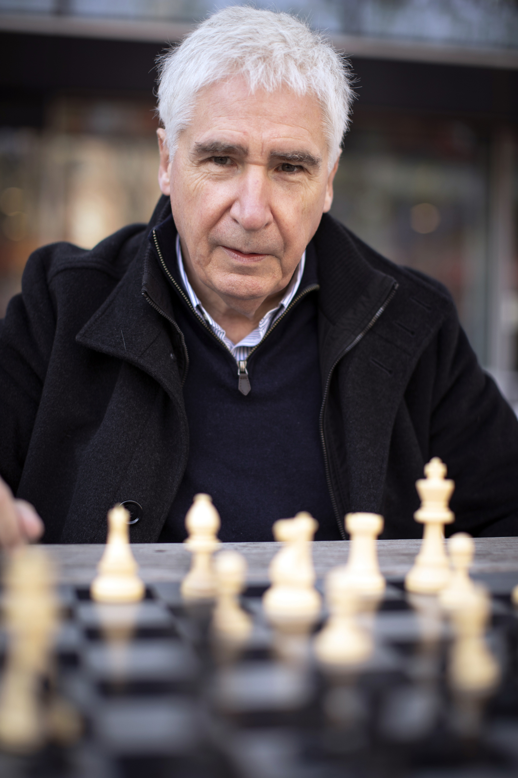 Man playing chess against computer Stock Photo