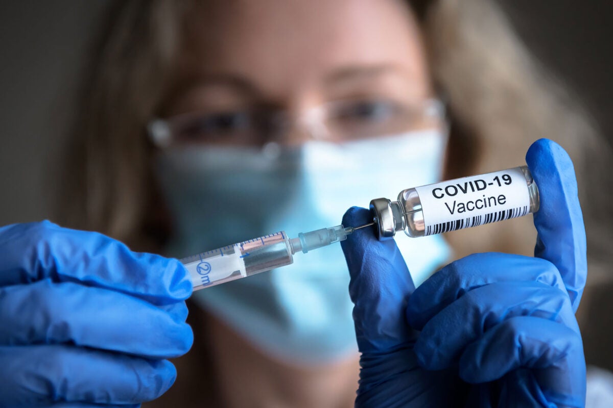 Nurse holding COVID vaccine.