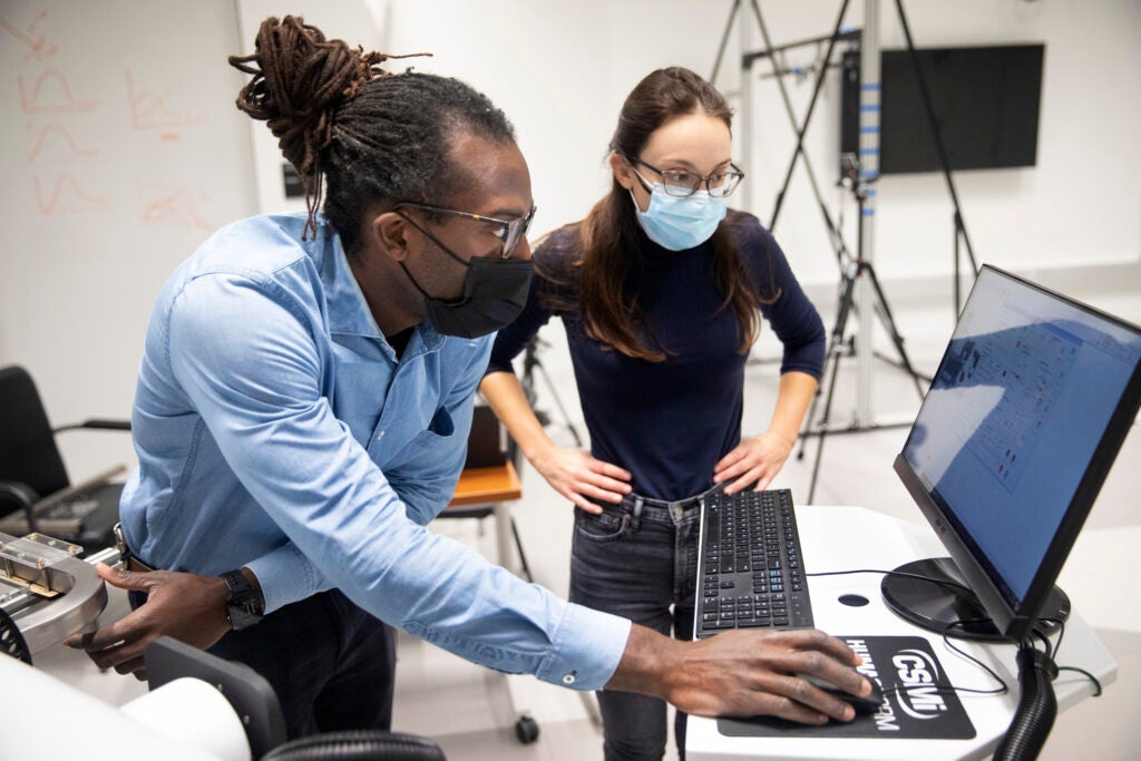 Inside the Harvard Biodesign Lab, Oluwaseun Araromi, a postdoctoral research fellow, works with Lauren Baker.
