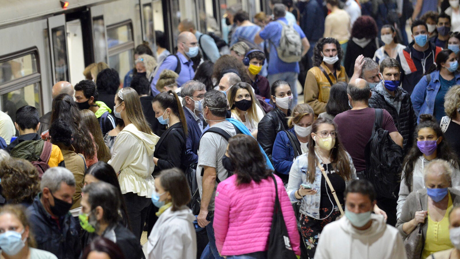 People in a crowd wearing masks.