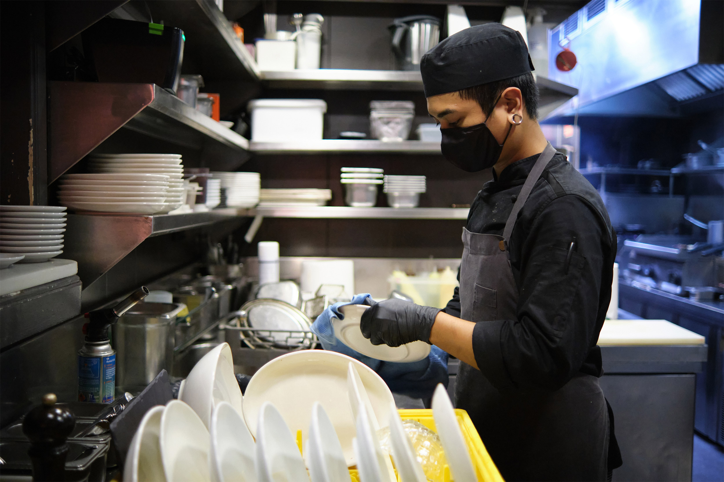 Worker washing dishes.