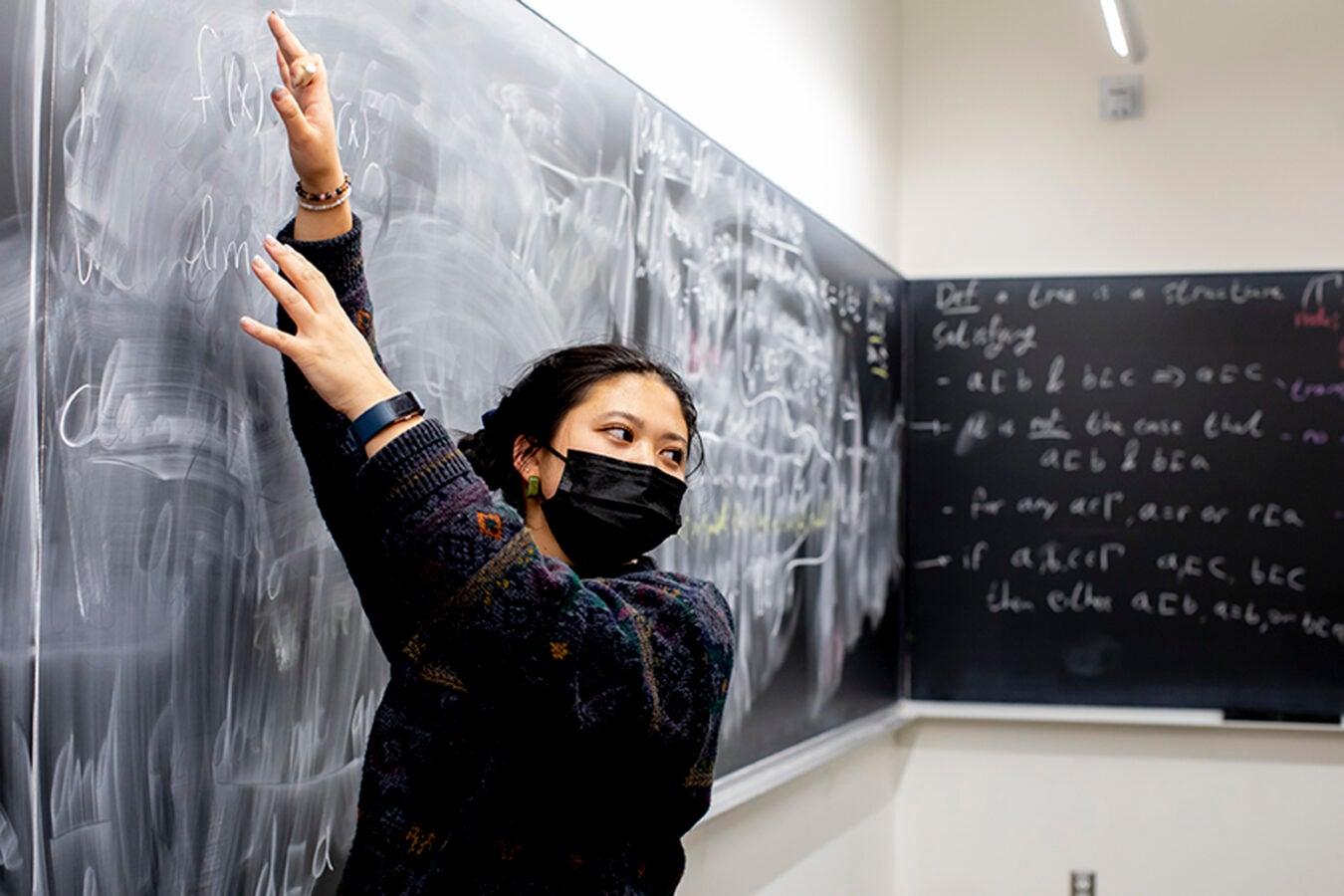 Jocelyn Wang uses chalkboard at Math Question Center.