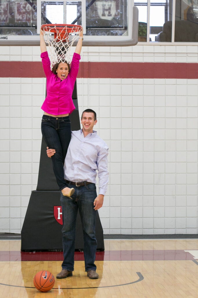 Lindsay Hallion Miller and Doug Miller pose on basketball court.