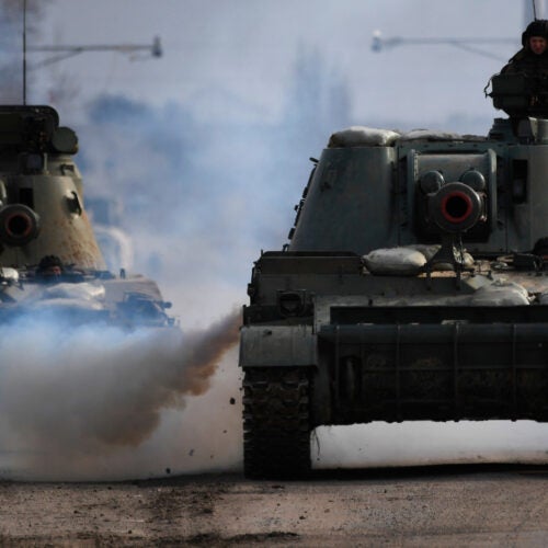 Armoured vehicles drive along a road in Armyansk