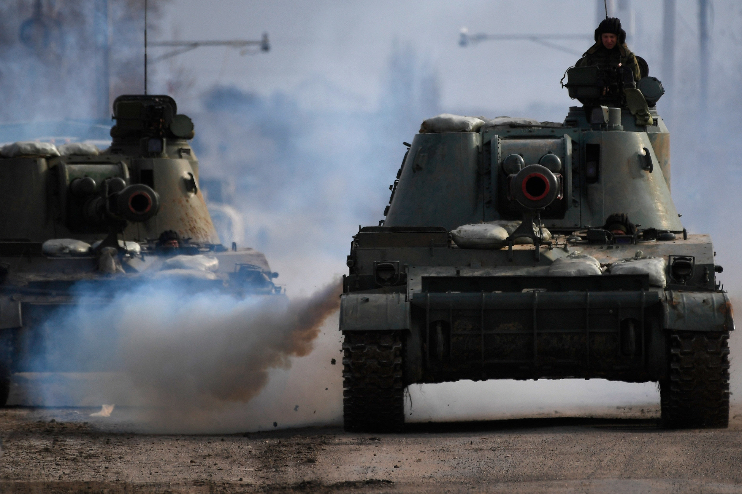 Armoured vehicles drive along a road in Armyansk