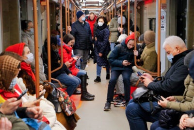 Russian reading smartphones on the subway.
