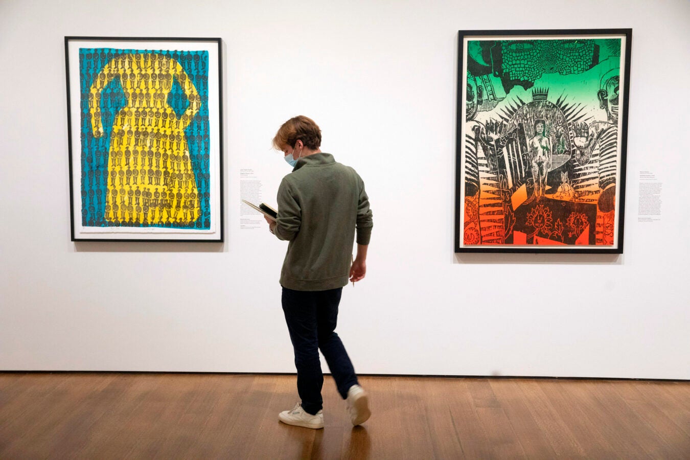 A student studies Hagar’s Dress, 2007 (left) by Janet Taylor Pickett and Untitled (color), 2006 (right) by Danny Alvarez.