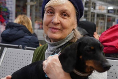 Ukrainian refugee holds family dog.
