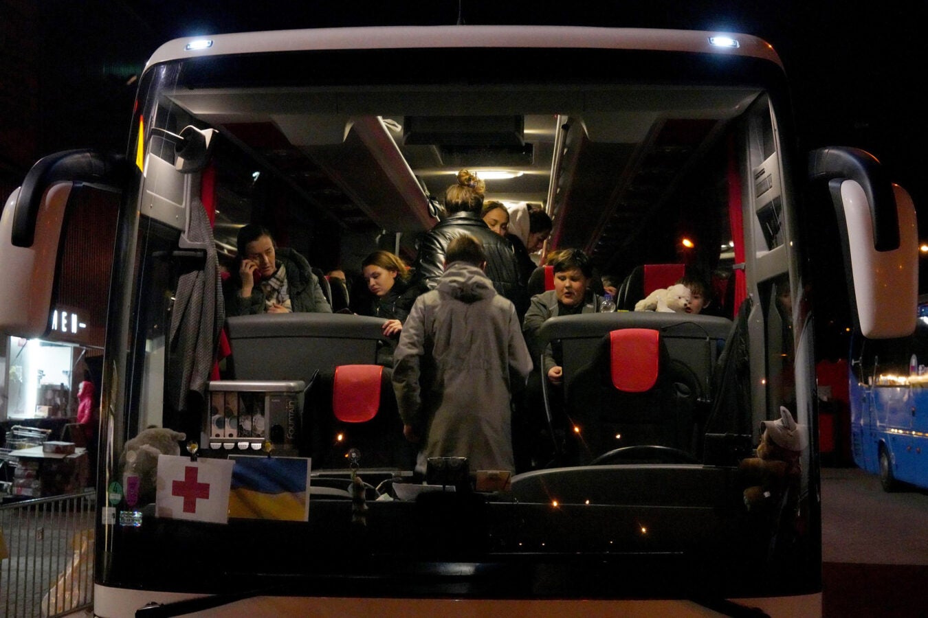 Ukrainian refugees board bus.