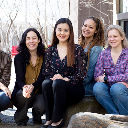 Elizabeth Guo, Samantha C.W. O’Sullivan, Melissa Franklin, Cora Dvorkin, and Jenny Hoffman pose together outside the Science Center.