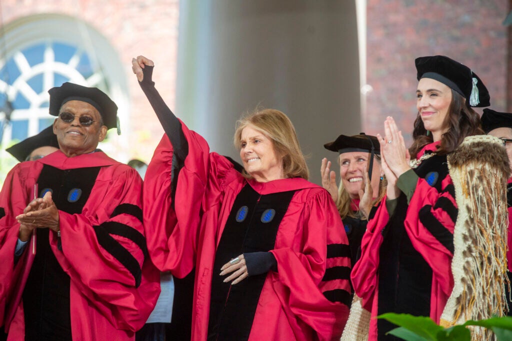 Gloria Steinem raises for fist after being awarded her honorary degree.