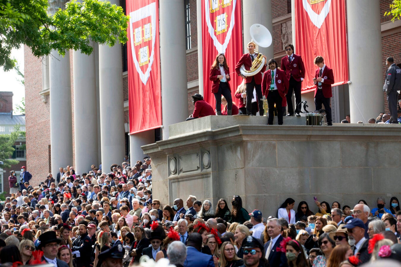 The Harvard Band gathers at Widener Library with a sea of family members below.