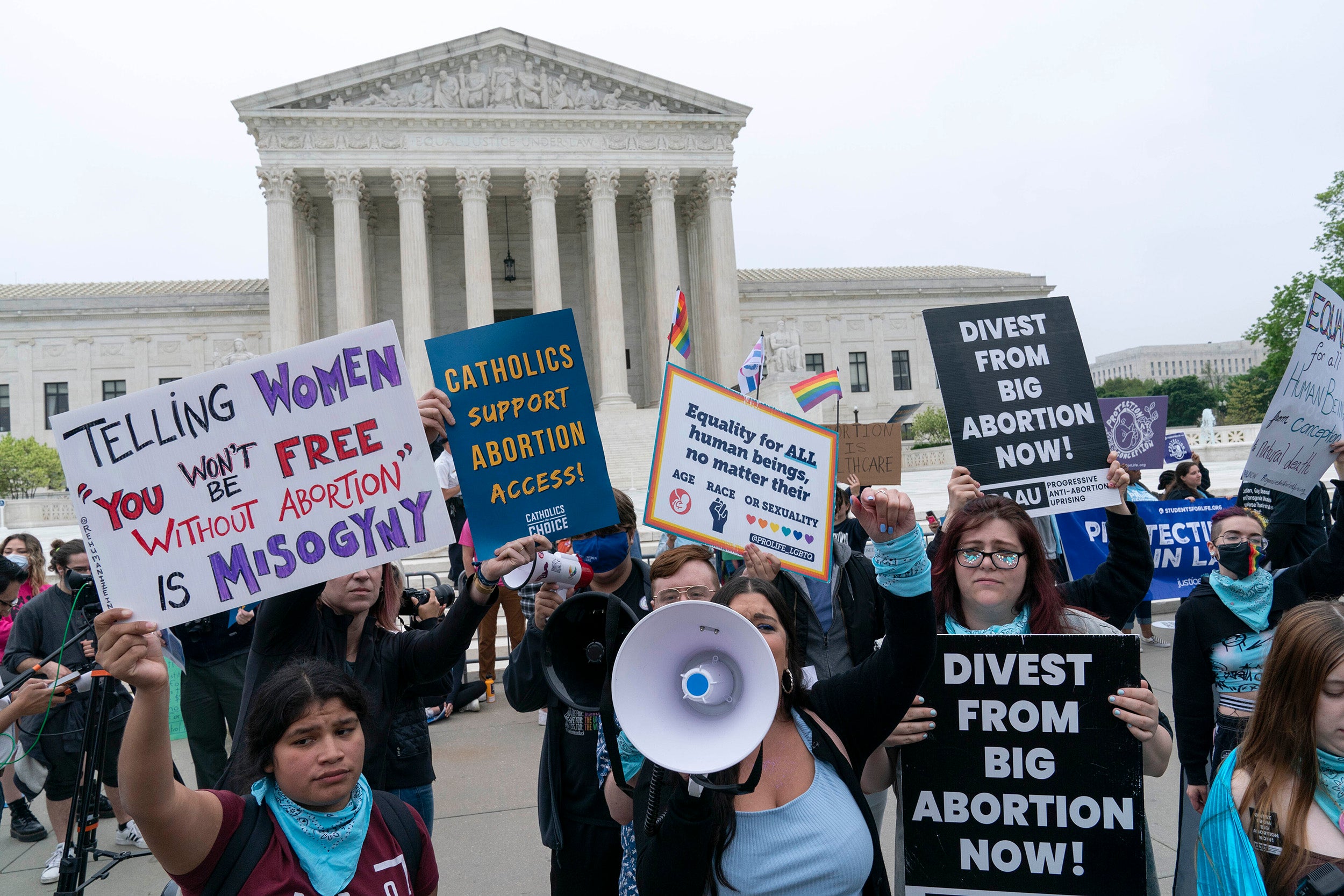 Demonstrators hold signs for and against abortion rights outside Supreme Court.