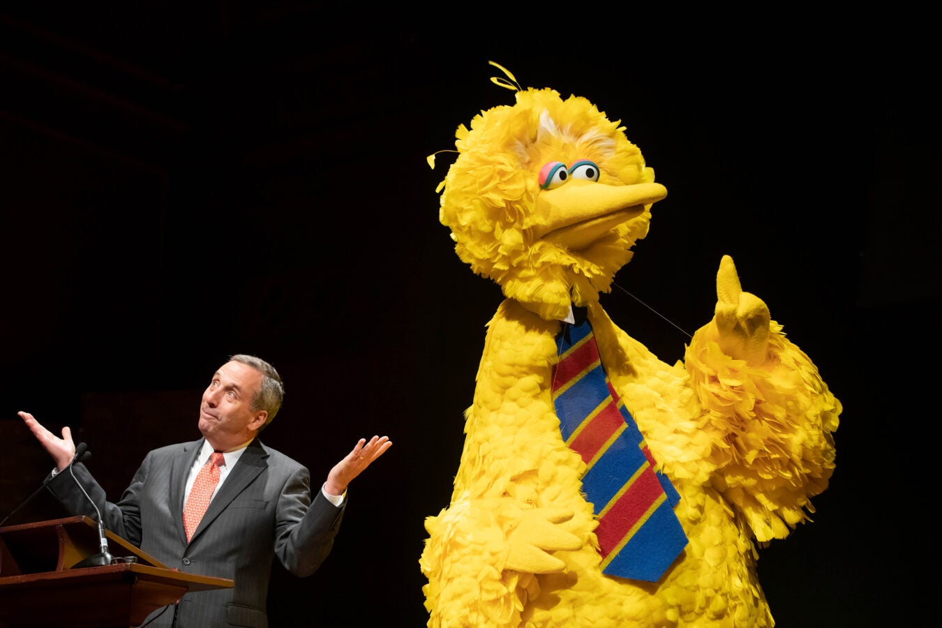 Larry Bacow with Big Bird at Sesame Street 50th anniversary celebration.