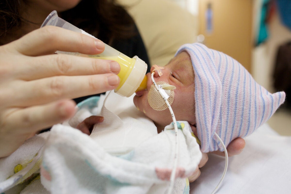 A premature baby feeding on breastmilk.