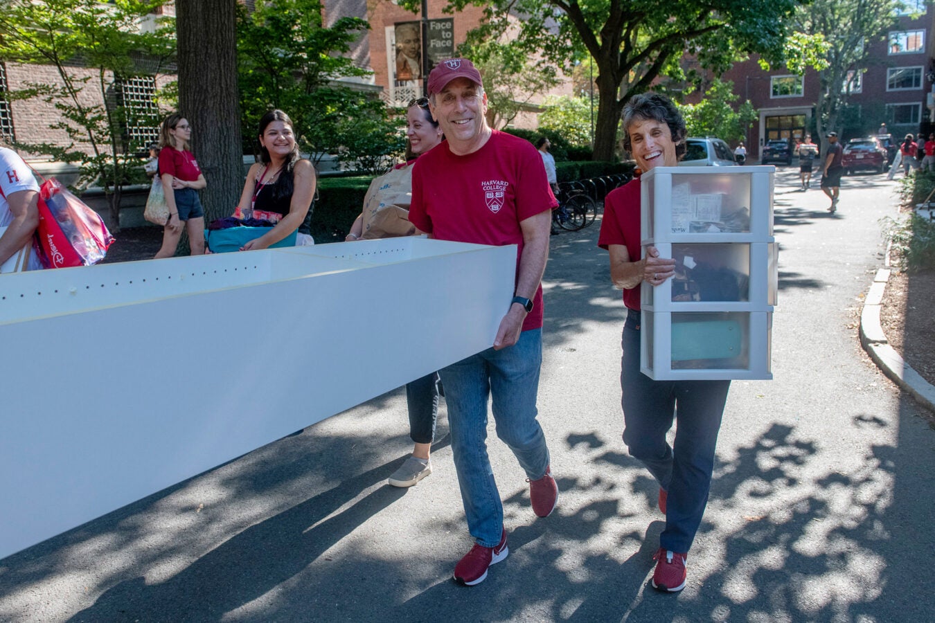 Harvard President Larry Bacow and Adele Fleet Bacow lend a hand.