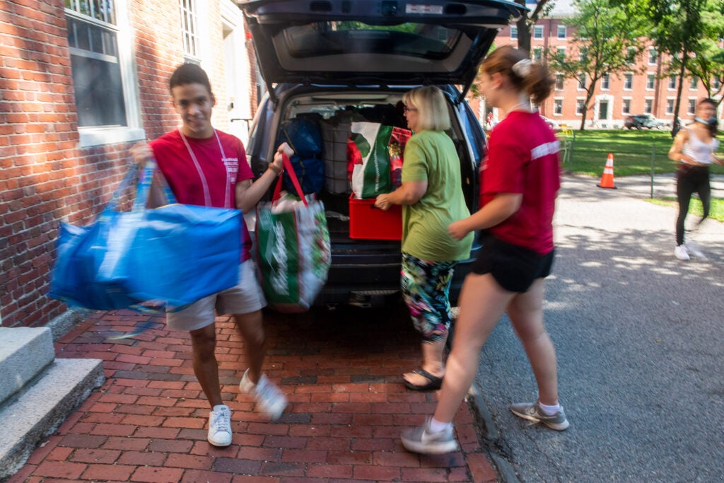 Move-in team helping unload a car.