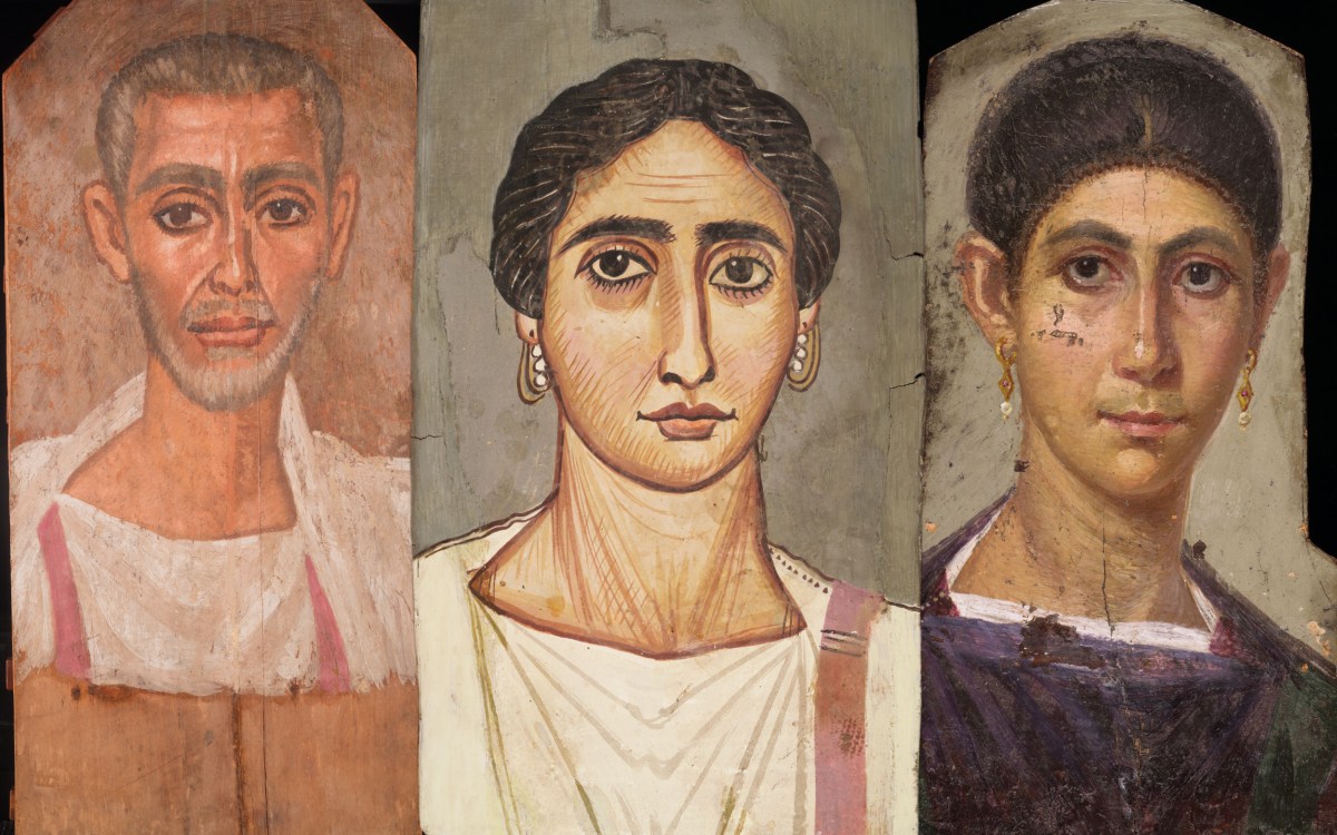 Three mummy portraits of bearded man wearing white tunic, woman wearing white tunic with purple sash, and woman wearing a purple tunic.