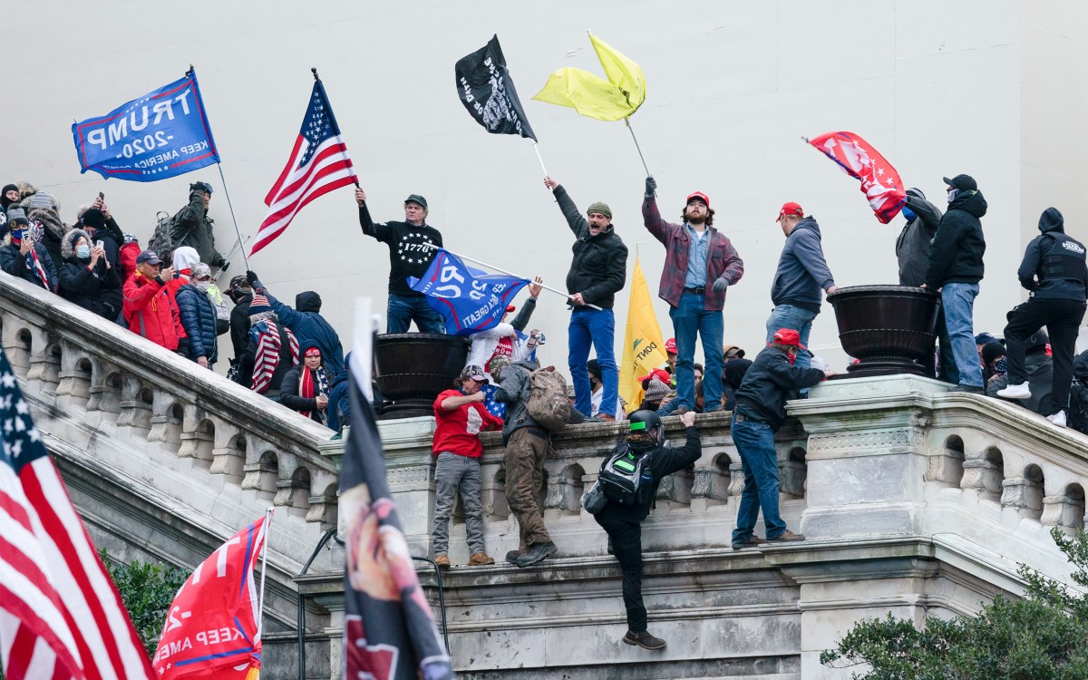 Rioters wave flags on the West Front of the U.S. Capitol in Washington on Jan. 6, 2021.