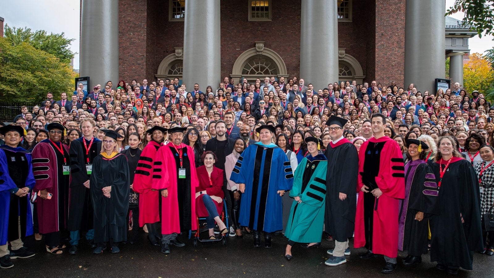 Harvard Extension School students and Deans pose for a group photo outside of Memorial Church before their convocation ceremony.