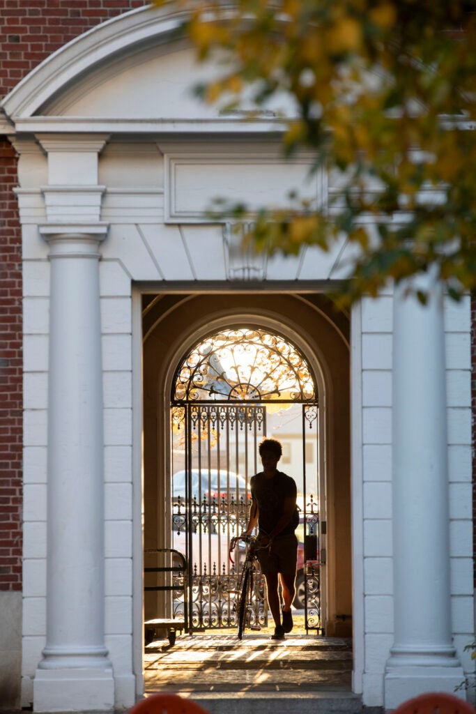 A bicyclist enters the Eliot House courtyard.