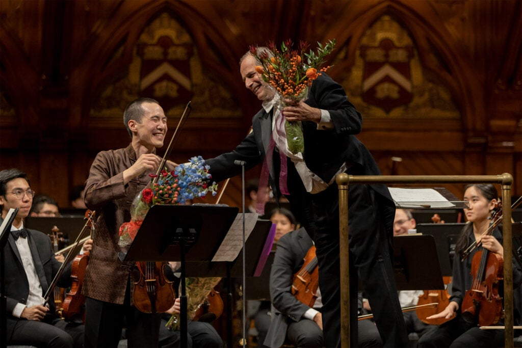 Maestro Federico Cortese (left) and Joseph Lin ’00 celebrate the performance of the Yannatos Violin Concerto