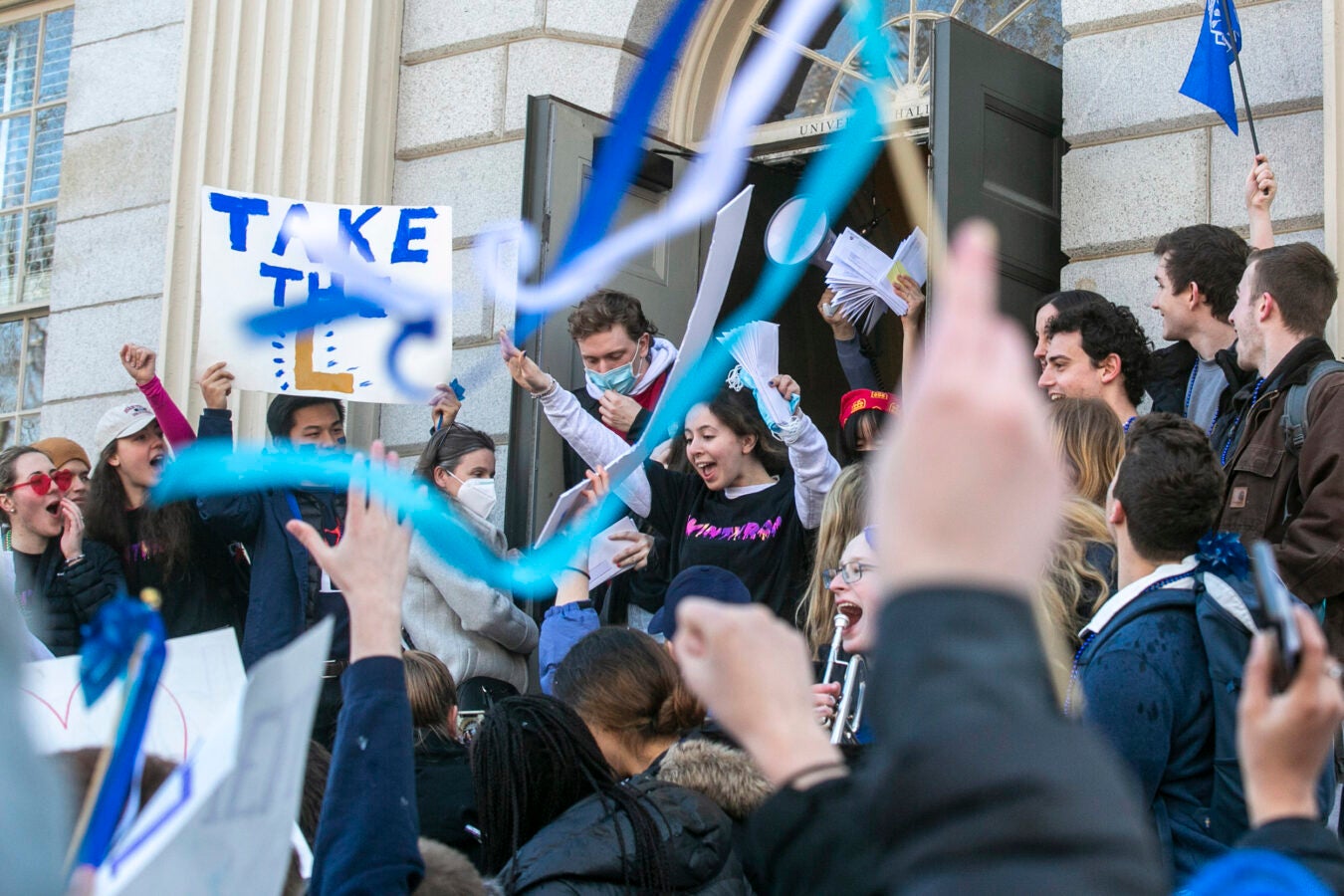 Students wave streamers, signs as envelopes arrive with House assignments.