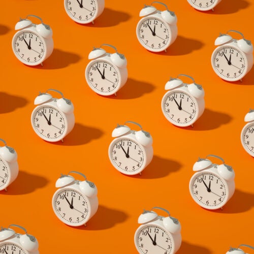 Photo illustration of alarm clocks.