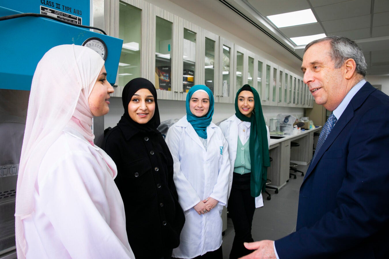 President Larry Bacow visits the West Bank and Al-Quds University on the Abu Dis Campus. Bisan Safi (from left), Munira Odetallah, Yasmin Attili, and Hana Shkirat speak with Bacow during his tour of the campus.
