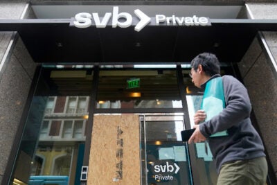 A pedestrian passes a Silicon Valley Bank branch