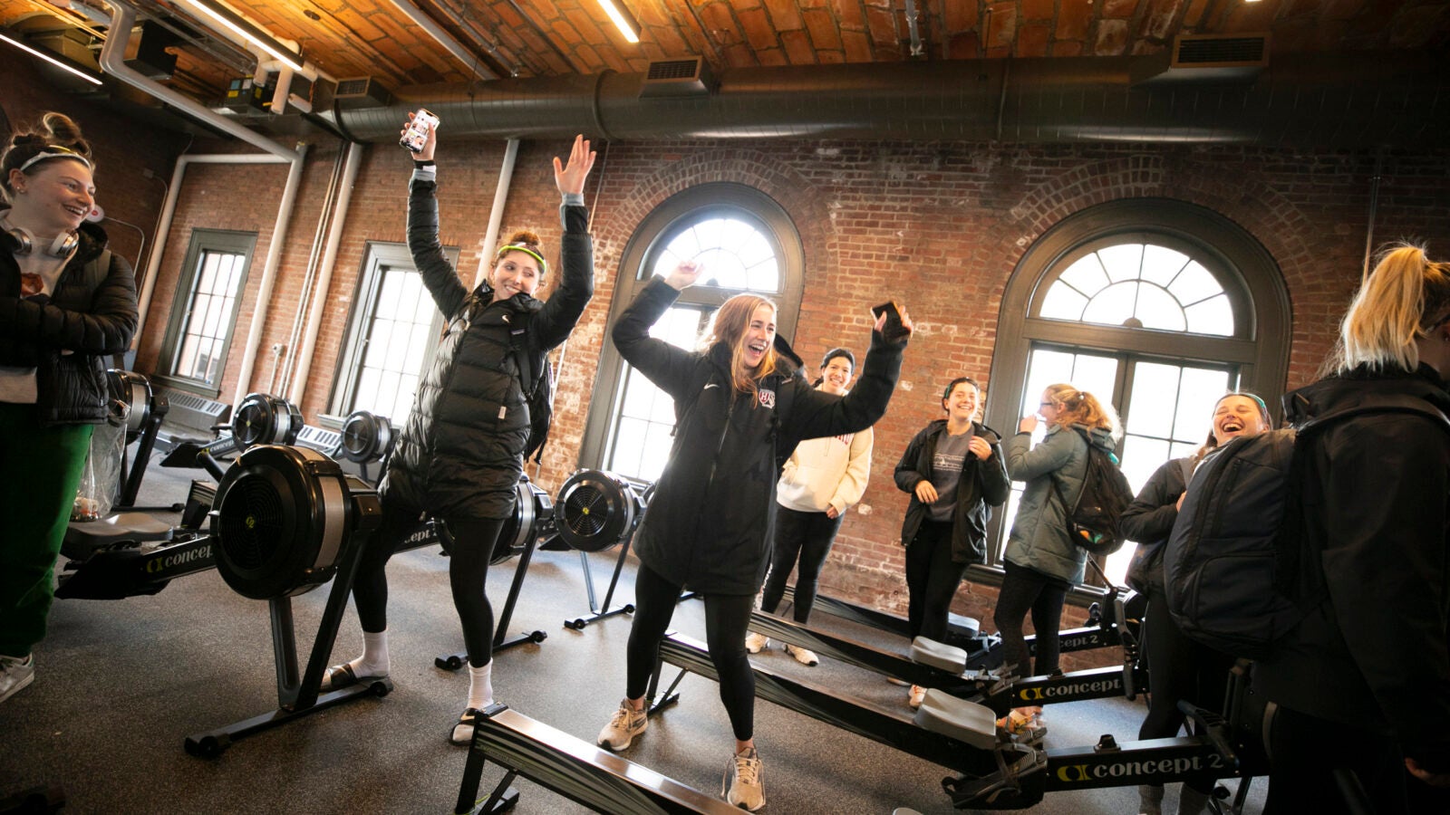 Members of rowing team dance in newly renovated Weld Boathouse.