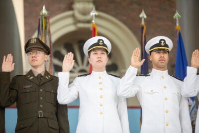 Aaron Boehm, GSAS, (from left) Elisabeth Aigeldinger, Isaiah Coleman, Navy take their oath.